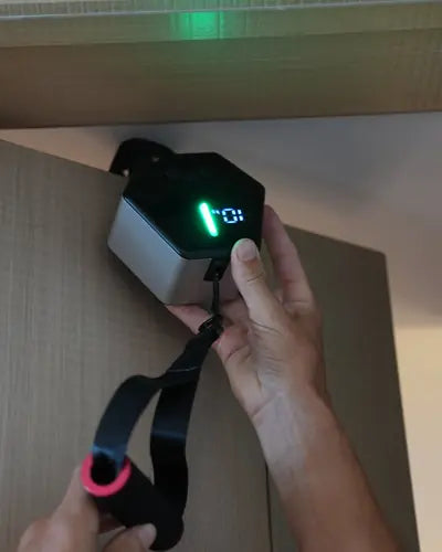 Hands attaching Go-Tone to the top of a door