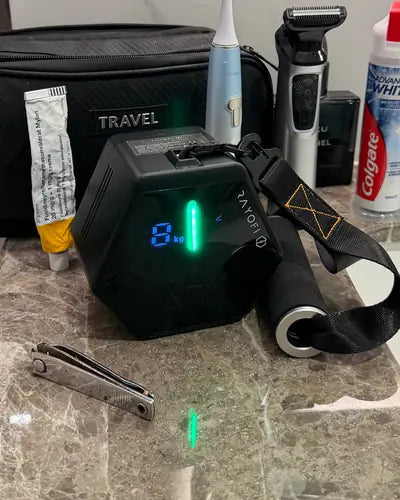 Go-Tone Pro on a bathroom counter next to a travel toiletry bag